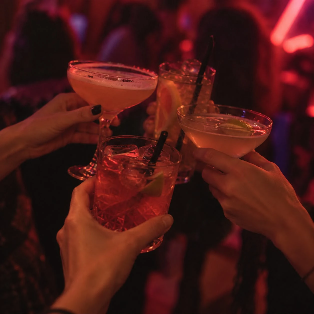 Friends raising cocktails at the Platform bar