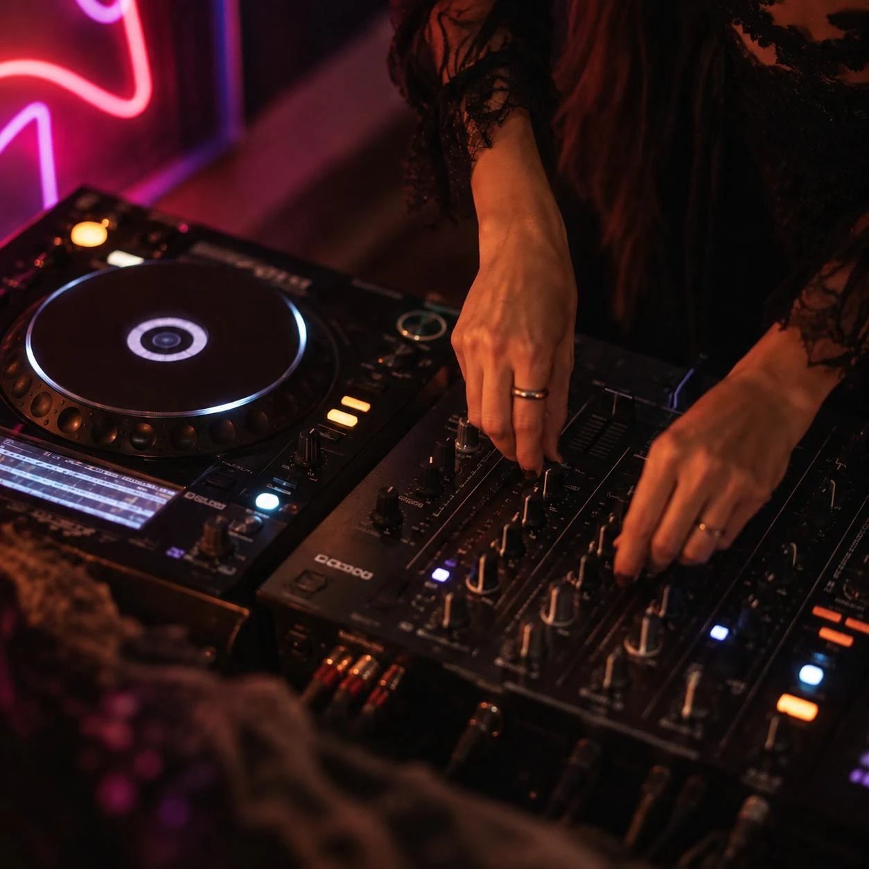 DJ mixing on decks under neon lights at Platform