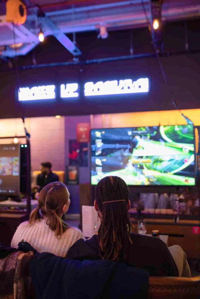 Friends playing console games in a Platform booth