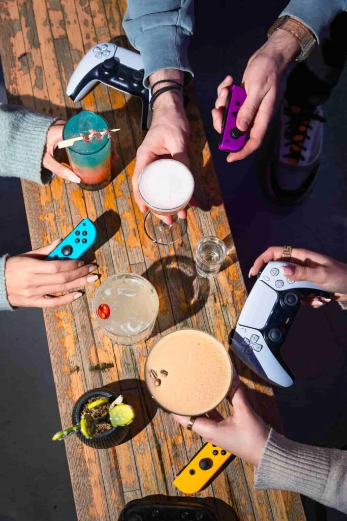 Cocktails and Nintendo Switch controllers on a table at Platform